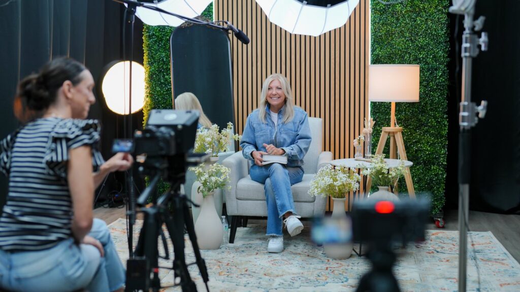 Professional video recording session with multi camera setup, studio lighting, and styled interview set